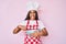 Young african american woman with braids cooking using baker whisk sticking tongue out happy with funny expression