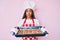 Young african american woman with braids wearing baker uniform holding homemade cookies puffing cheeks with funny face