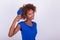 Young African American woman combing her frizzy afro hair - Black people