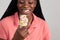 Young African American woman enjoying a multi colored ice cream treat.