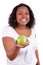 Young african american woman giving an green apple