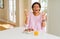Young african american woman having healthy breakfast in the morning at home crazy and mad shouting and yelling with aggressive