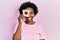 Young african american woman holding bread loaf with heart shape smiling with a happy and cool smile on face