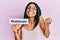 Young african american woman holding gratitude message paper screaming proud, celebrating victory and success very excited with