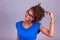 Young African American woman holding her frizzy afro hair - Blac