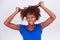 Young African American woman holding her frizzy afro hair - Blac