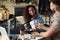 Young African American woman interviewing man in modern radio studio