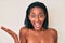 Young african american woman naked over background celebrating victory with happy smile and winner expression with raised hands