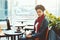 Young African-American woman in office cafe with cake