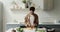 Young African American woman prepare roasted vegetables at home kitchen