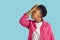 Young african american woman is showing facepalm gesture on blue background.