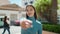 Young african american woman smiling confident shake hand at street