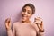 Young african american woman smiling happy holding professional orthodontic denture with metal braces and removable invisible