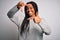 Young african american woman standing casual and cool over grey isolated background smiling making frame with hands and fingers