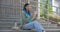 Young African American woman student or freelancer making video call using tablet pc pad computer sitting outdoor