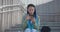 young african american woman student typing writing message on the mobile phone while sitting outdoors on steps