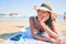 Young african american woman on vacation smiling happy laying on the towel at the beach