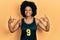 Young african american woman wearing basketball uniform looking confident with smile on face, pointing oneself with fingers proud