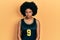 Young african american woman wearing basketball uniform skeptic and nervous, frowning upset because of problem
