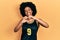 Young african american woman wearing basketball uniform smiling in love doing heart symbol shape with hands