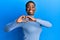 Young african american woman wearing casual clothes smiling in love doing heart symbol shape with hands