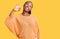 Young african american woman wearing casual clothes smiling positive doing ok sign with hand and fingers