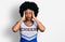 Young african american woman wearing cheerleader uniform with hand on head for pain in head because stress