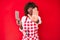 Young african american woman wearing cook apron holding knife with open hand doing stop sign with serious and confident