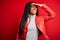 Young african american woman wearing cool fashion leather jacket over red isolated background very happy and smiling looking far