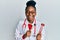 Young african american woman wearing doctor uniform holding tuning fork smiling and laughing hard out loud because funny crazy