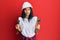 Young african american woman wearing hardhat holding wrench relaxed with serious expression on face