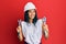 Young african american woman wearing hardhat holding wrench smiling with a happy and cool smile on face