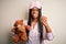 Young african american woman wearing pajama and eye mask hugging teddy bear annoyed and frustrated shouting with anger, crazy and