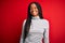 Young african american woman wearing turtleneck sweater over red isolated background with a happy and cool smile on face