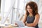 Young African American woman working with tablet in office