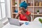 Young african american woman worried using laptop drinking coffee at home