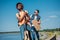 young african amrican man with guitar hitchhiking