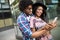 Young african couple pose for holiday selfie in city