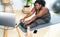 Young African curvy woman doing pilates online fitness class with laptop at home