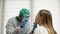 Young African doctor takes a throat swab from a female patient. Coronovirus test, test for determining coronovirus