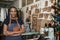 Young African female leather worker standing in her studio