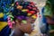 Young African girl with beautifully decorated hair dancing, very colorful with intended motion blur, Cabinda, Angola