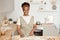 Young African housewife cutting homemade dough for pastry