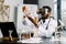 Young African male doctor, scientist, virologist, wearing virtual reality glasses for imagination, conducting research