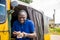 young african man driving a rickshaw taxi counting his money smiling