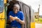 young african man driving a rickshaw taxi counting his money smiling