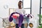 Young african man holding laundry basket smiling looking to the side and staring away thinking