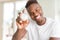 Young african man holding silver retro stopwatch counting time