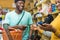 young african man paying in a retail store with his credit card at a point of sale terminal