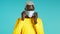 Young african man puts on face medical mask during coronavirus pandemic. Portrait on blue background. Protection with